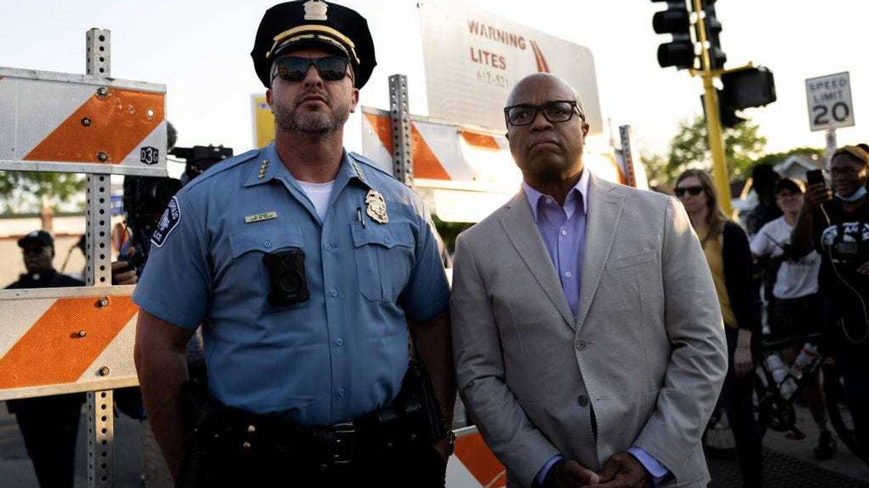 Minneapolis Police Chief Brian O'Hara (L) and former Chief Medaria Arradondo (R) arrive as people gather for a vigil at George Floyd Square on May 25, 2023 in Minneapolis, Minnesota.