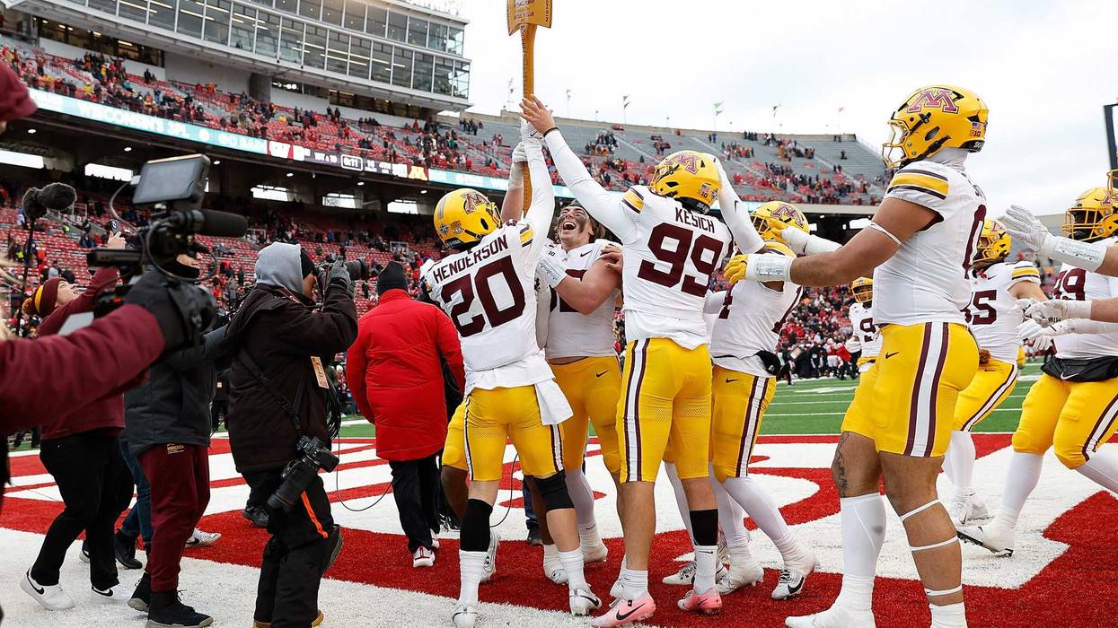 Minnesota Golden Gophers players celebrates with the Ax after a win over the Wisconsin Badgers at Camp Randall Stadium on November 29, 2024 in Madison, Wisconsin.