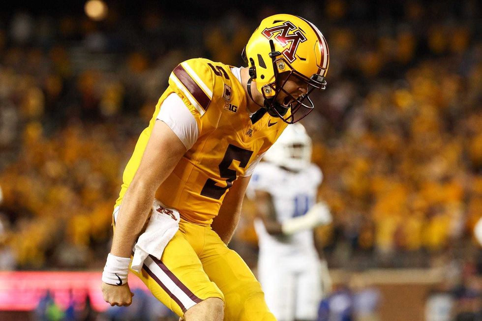 Minnesota Golden Gophers quarterback Drake Lindsey (5) celebrates wide receiver Jalen Smith
