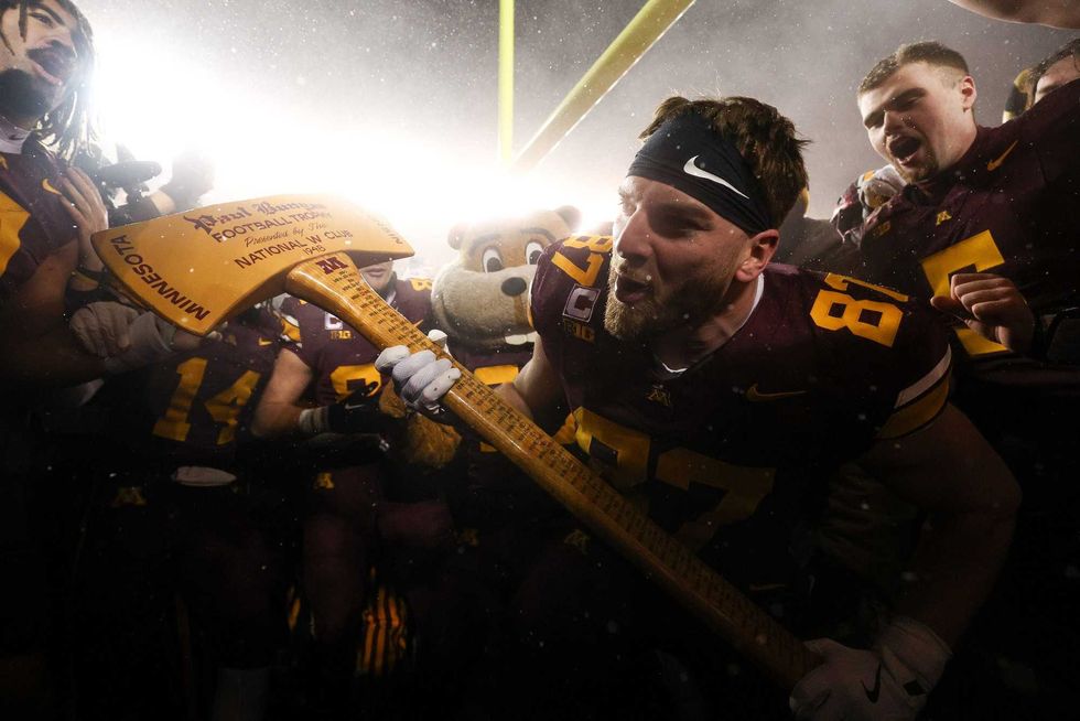 Minnesota Golden Gophers tight end Drew Biber (87) celebrates with Paul Bunyan’s Axe after the game against the Wisconsin Badgers at Huntington Bank Stadium.