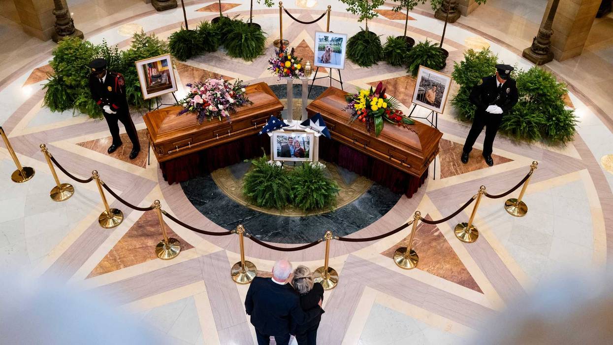 Minnesota Gov. Tim Walz and first lady Gwen Walz look on as DFL Rep. Melissa Hortman, her husband Mark Hortman, and their dog Gilbert lie in state in the rotunda of the Capitol building on June 27, 2025 in St. Paul, Minnesota.