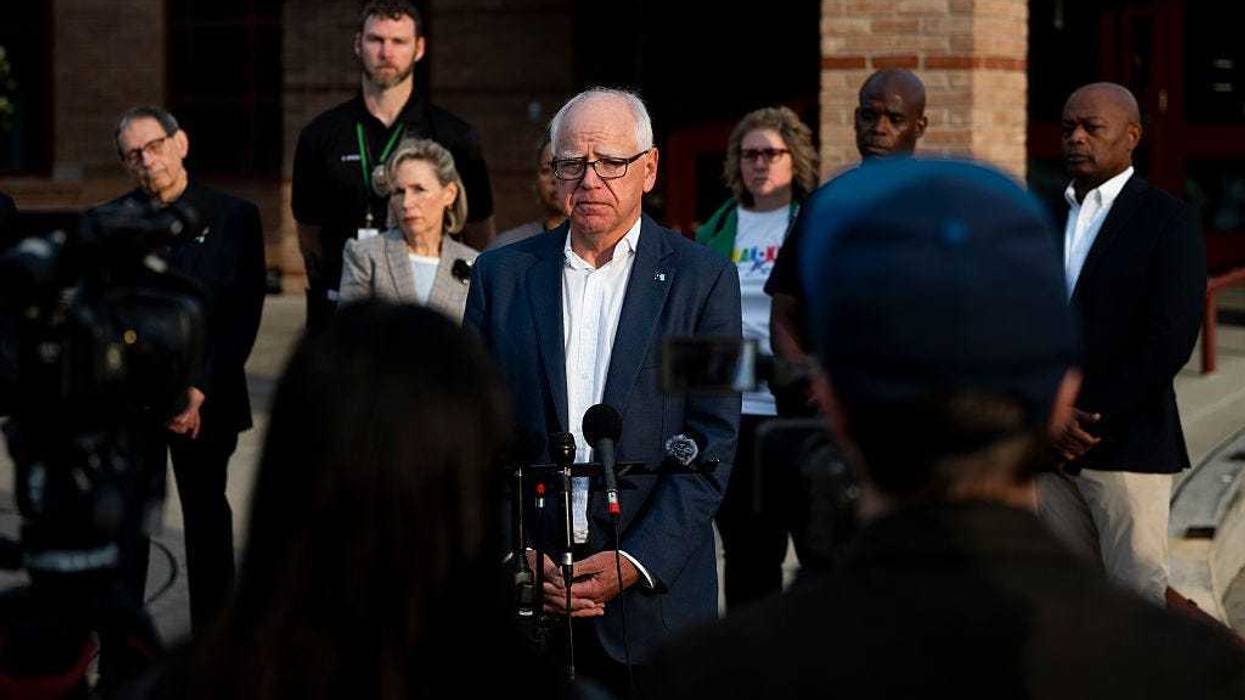 Minnesota Gov. Tim Walz (C) speaks to media gathered on the first day of school at Deerwood Elementary on September 2, 2025 in Eagan, Minnesota.