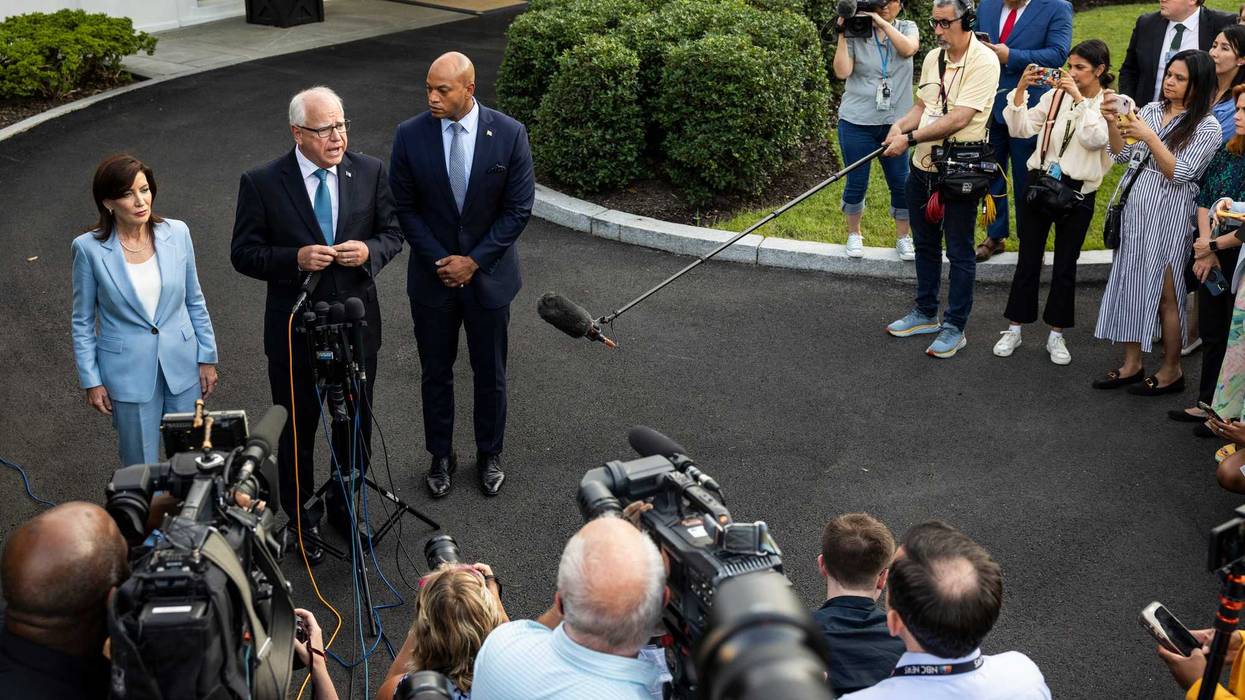 Minnesota Governor Tim Walz (center) speaks to reporters in front of the West Wing of the White House.