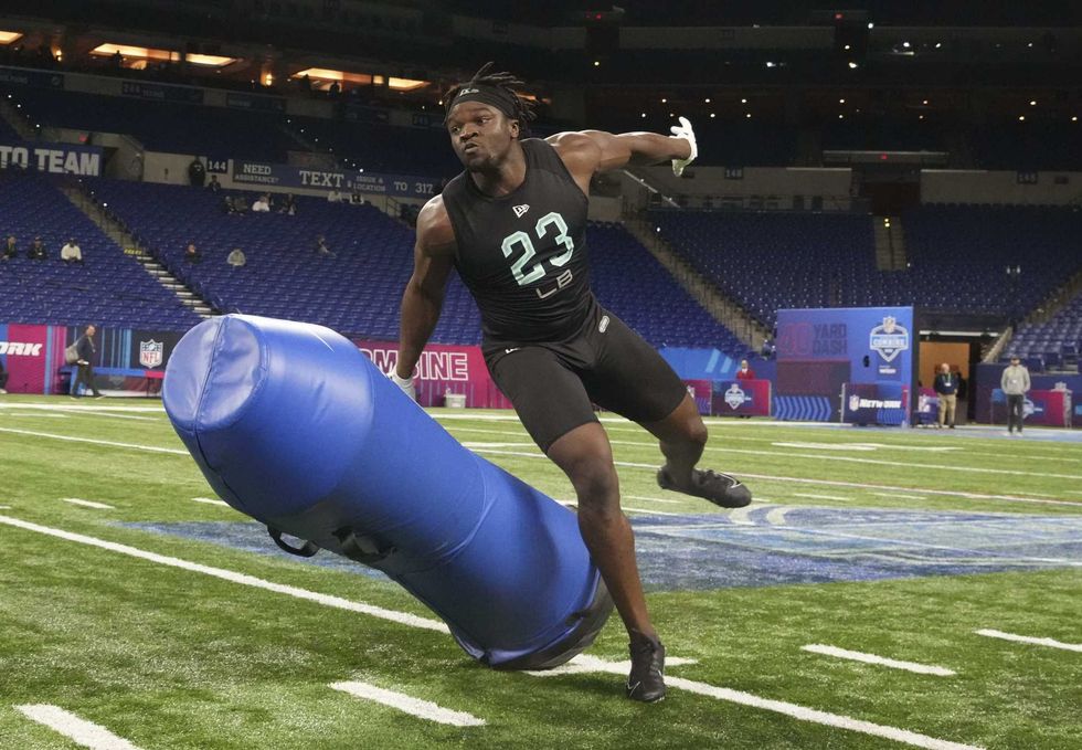 Minnesota linebacker Boye Mafe (LB23) goes through drills during the 2022 NFL Scouting Combine at Lucas Oil Stadium