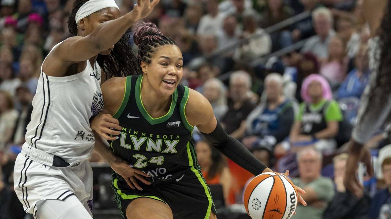 Minnesota Lynx forward Napheesa Collier (24) dribbles the ball past Golden State Valkyries guard Kaila Charles (6) in the first half during game one of round one for the 2025 WNBA Playoffs at Target Center.