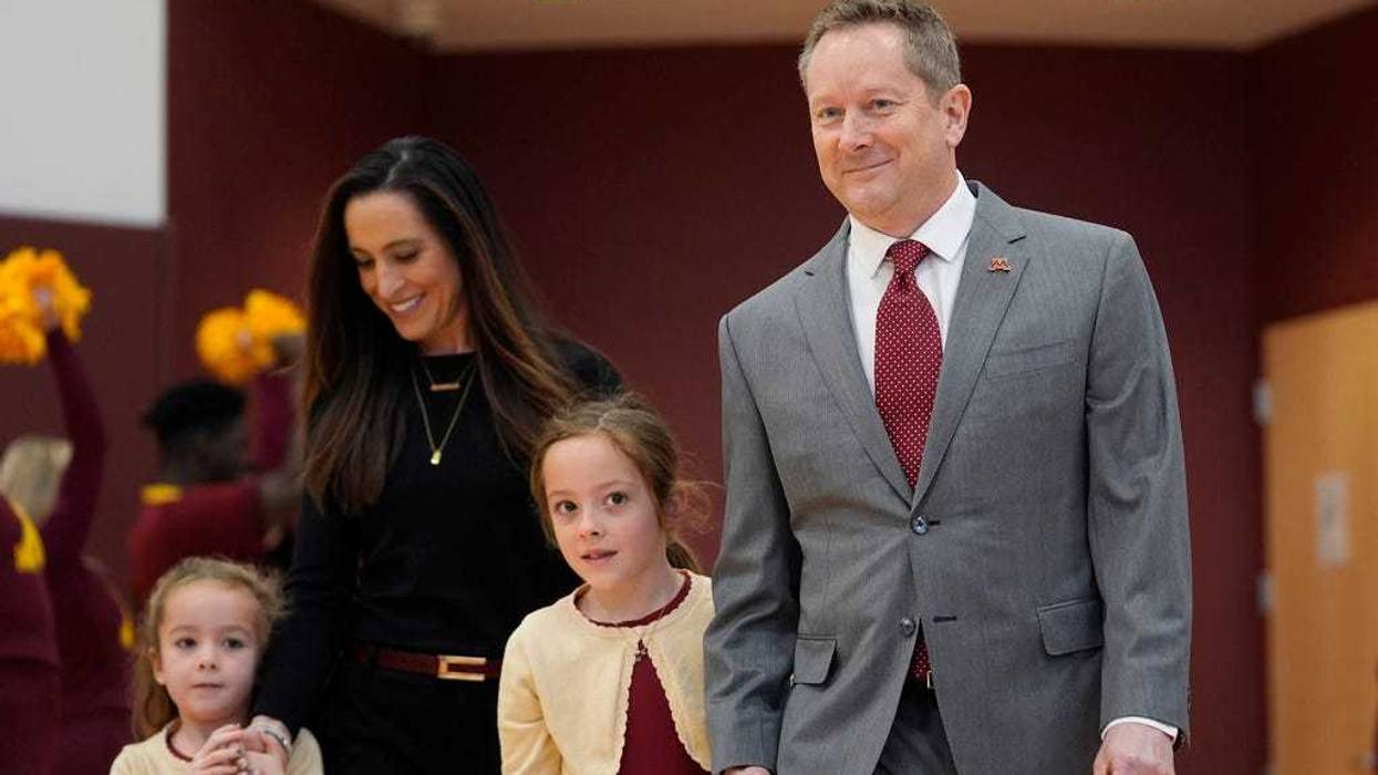 Minnesota's new head coach Niko Medved arrives with his family for an NCAA college basketball news conference, Tuesday, March 25, 2025, in Minneapolis.