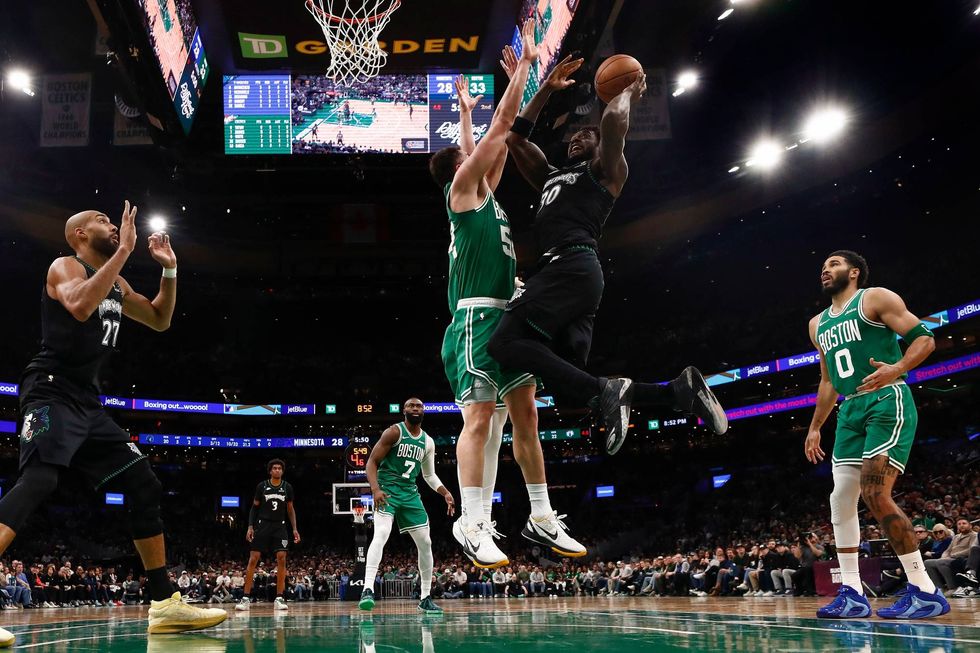 Minnesota Timberwolves getds off a shot against Luka Garza #52 of the Boston Celtics during the second half at TD Garden on March 22, 2026 in Boston, Massachusetts.
