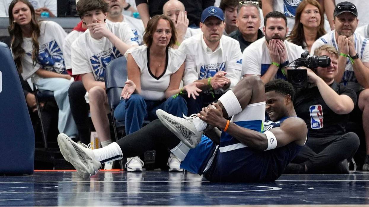 Minnesota Timberwolves guard Anthony Edwards (5) grabs his leg during the first half of Game 2 of an NBA basketball second-round playoff series against the Golden State Warriors, Thursday, May 8, 2025, in Minneapolis.