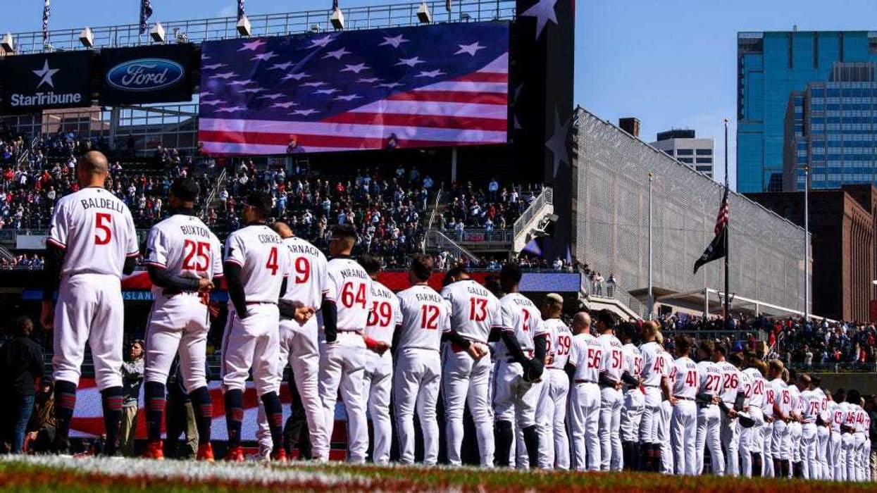 Minnesota Twins players line up for the National Anthem before the home opener against the Houston Astros at Target Field on April 7, 2023 in Minneapolis, Minnesota.