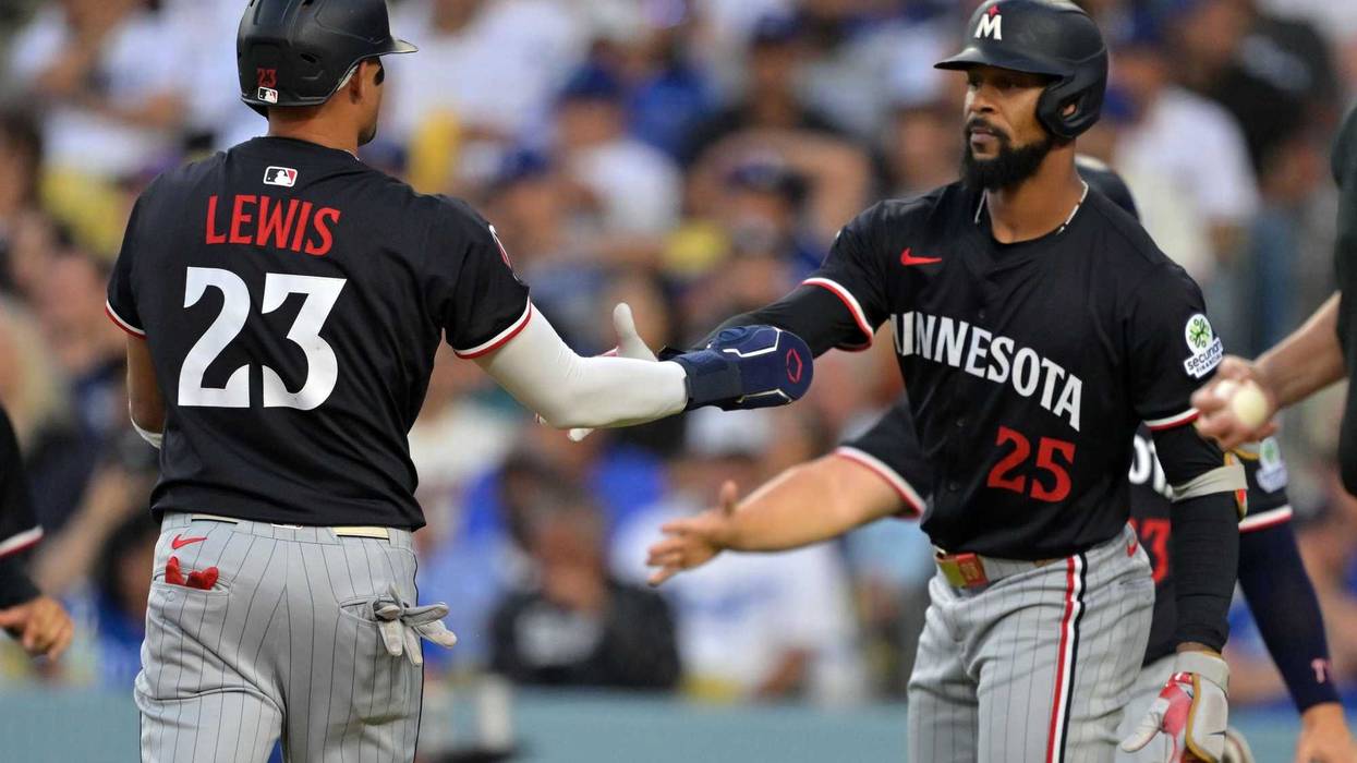Minnesota Twins third base Royce Lewis (23) and outfielder Byron Buxton (25) react after scoring against the Los Angeles Dodgers in the first inning at Dodger Stadium. After a flurry of trades gutted much of the Twins roster, these two are going to have to lead a very young core of players.