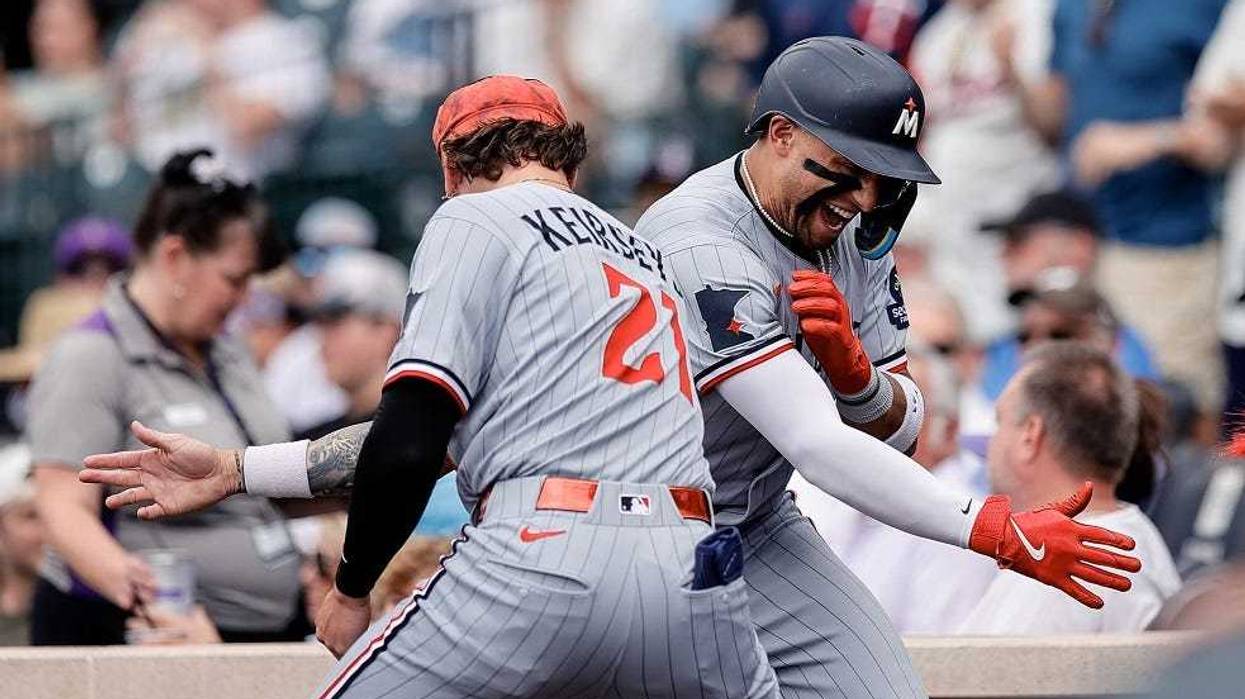 Minnesota Twins third baseman Royce Lewis (23) celebrates his solo home run with outfielder DaShawn Keirsey Jr. (21) in the eighth inning against the Colorado Rockies at Coors Field.
