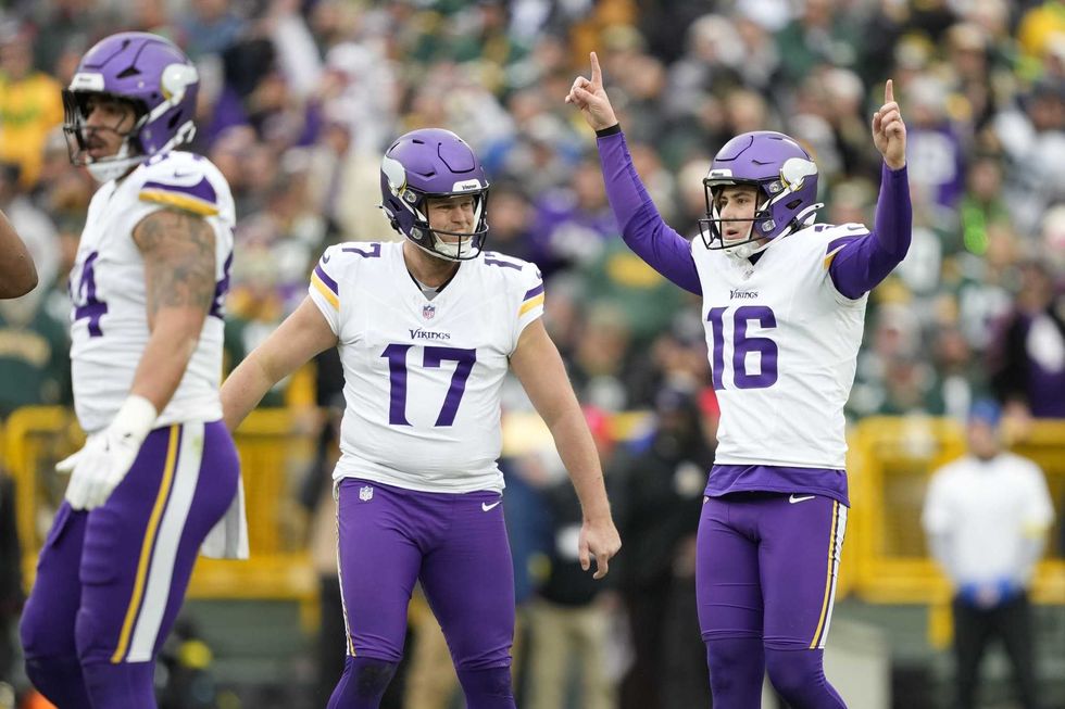 Minnesota Vikings place kicker Will Reichard (16) reacts with punter Ryan Wright (17) after kicking a field goal against the Green Bay Packers during the first half at Lambeau Field.