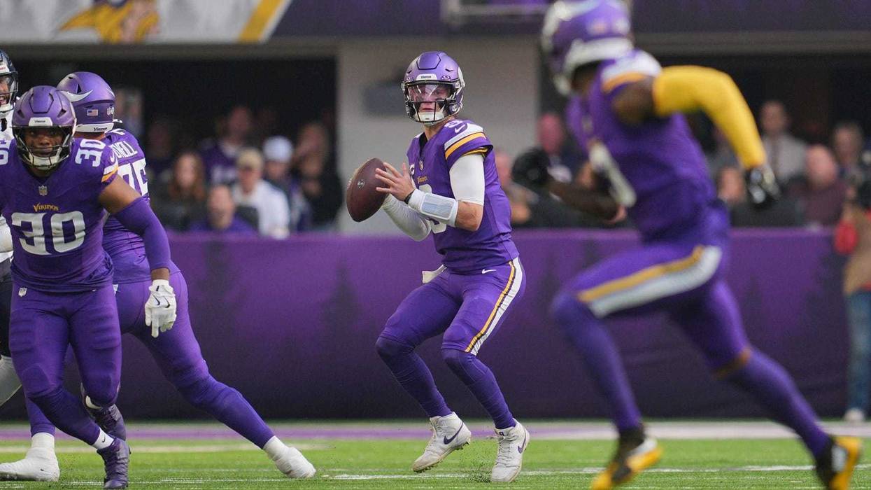 Minnesota Vikings quarterback J.J. McCarthy (9) looks to throw downfield during the first quarter against the Chicago Bears at U.S. Bank Stadium.