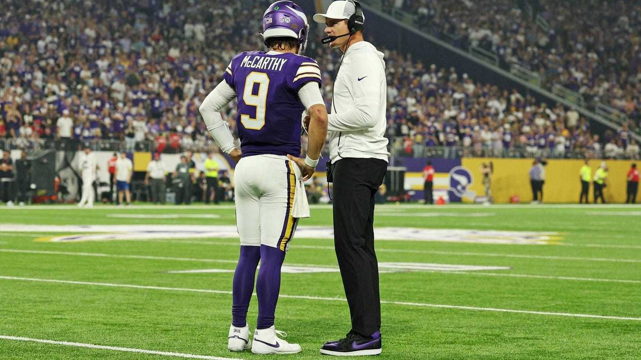 Minnesota Vikings quarterback J.J. McCarthy (9) speaks with Minnesota Vikings head coach Kevin O'Connell during the first half against the Atlanta Falcons at U.S. Bank Stadium.