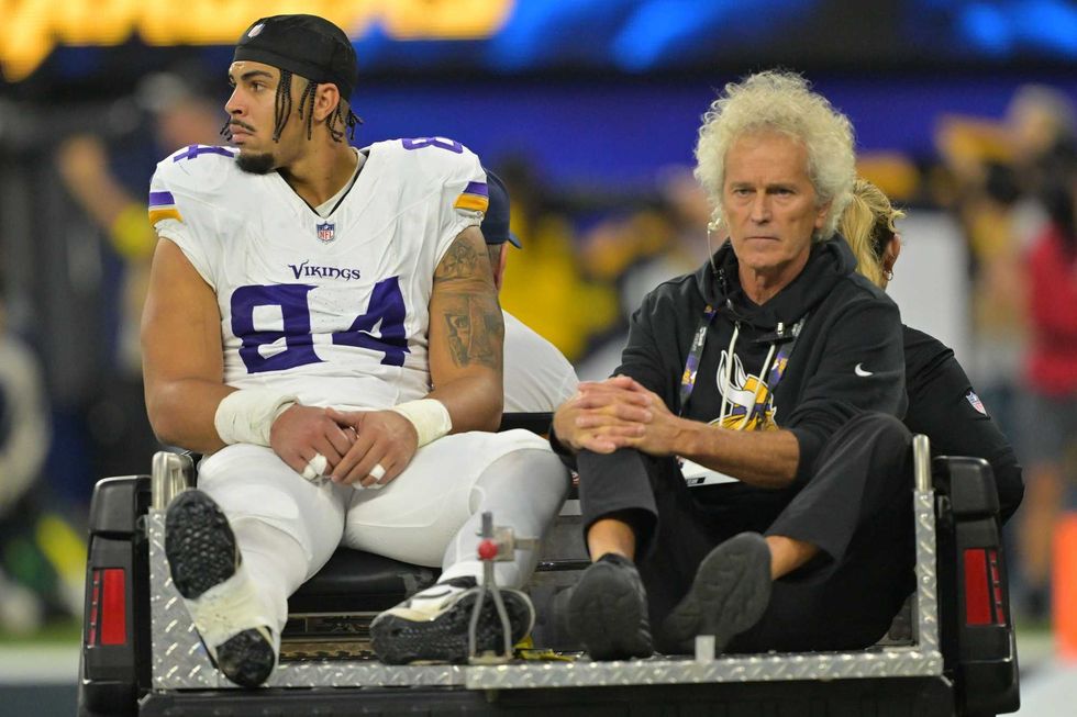 Minnesota Vikings tight end Josh Oliver (84) is carted off the field after an injury against the Los Angeles Chargers during the first half at SoFi Stadium.