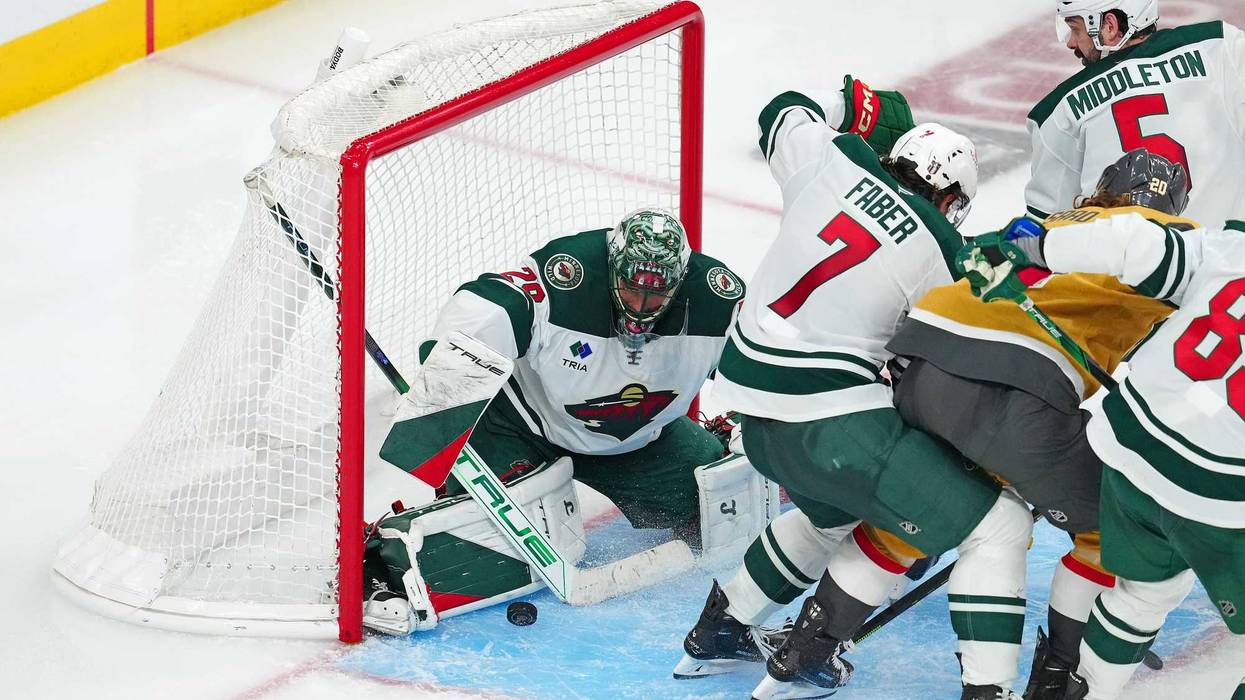 Minnesota Wild goaltender Marc-Andre Fleury (29) makes a save against the Vegas Golden Knights behind Minnesota Wild defenseman Brock Faber (7) during an overtime period of game five of the first round of the 2025 Stanley Cup Playoffs at T-Mobile Arena.