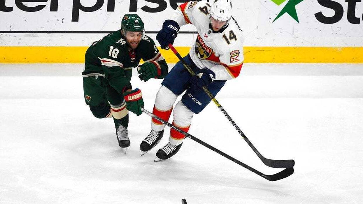 Minnesota Wild winger Jason Zucker (16) and Florida Panthers center Dominic Toninato battle for control of the puck during the first period of an NHL hockey game Monday, Jan. 20, 2020, in St. Paul, Minn.