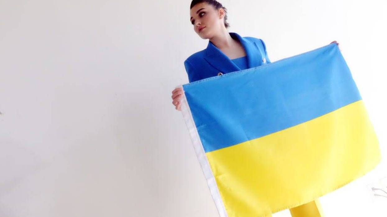 Miss Ukraine 2018 Veronika Didusenko holds a Ukrainian flag at a press conference with Gloria Allred on March 08, 2022 in Los Angeles. Didusenko discussed the impact of the Ukrainian war on mothers and children fleeing Ukraine.