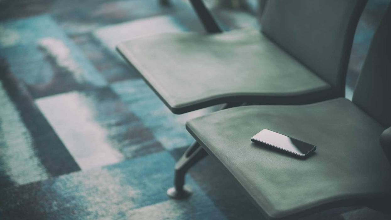 Missing phone on airport seat stock photo.