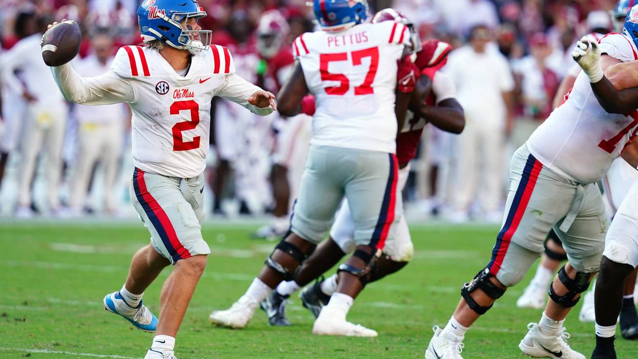 Mississippi Rebels quarterback Jaxson Dart (2) rolls out to pass against the Alabama Crimson Tide