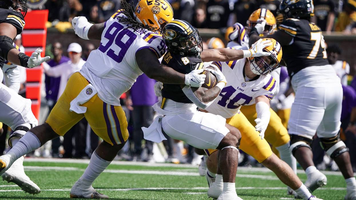 Missouri Tigers running back Nathaniel Peat (8) runs the ball and is tackled by LSU Tigers defensive tackle Jordan Jefferson