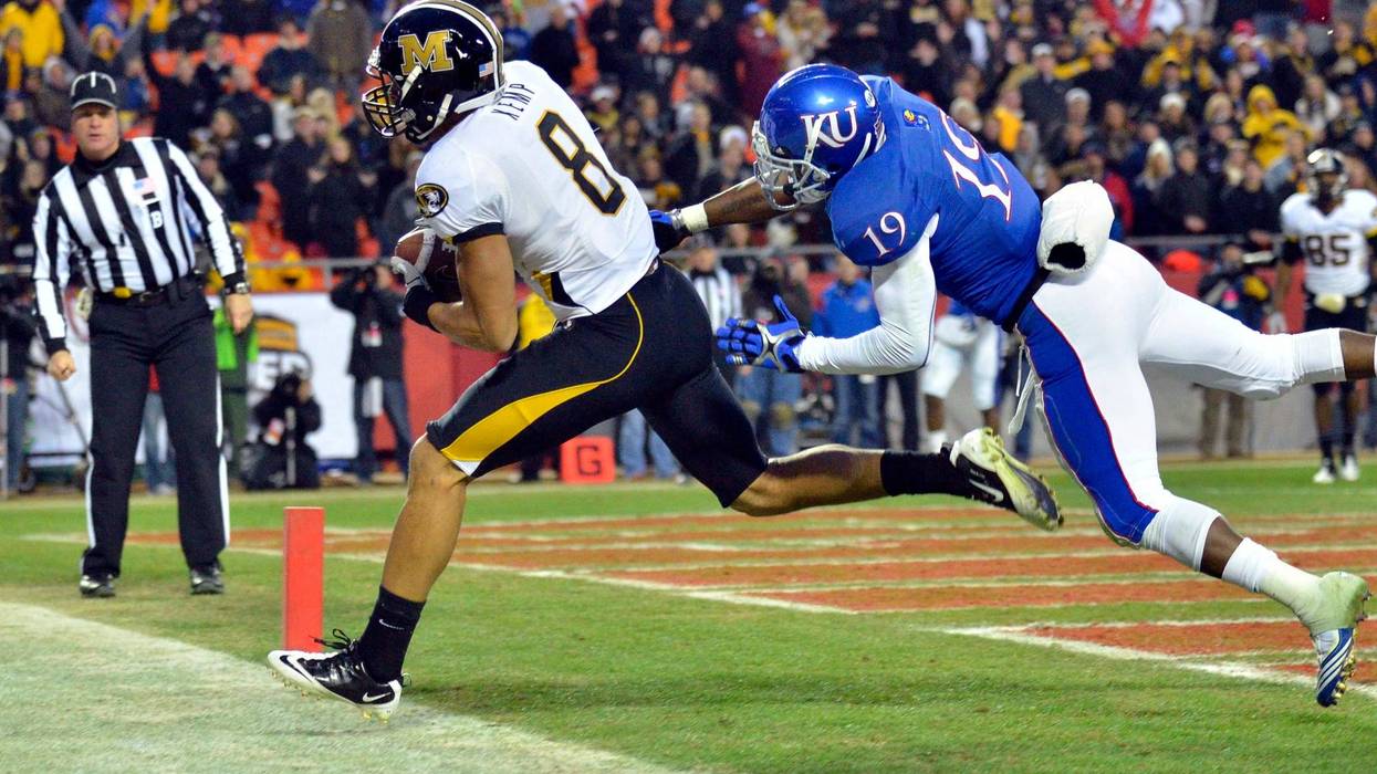 Missouri Tigers wide receiver Wes Kemp (8) catches a pass for a touchdown as Kansas Jayhawks cornerback Isiah Barfield (19) defends in the fourth quarter at Arrowhead Stadium. Missouri won 24-10.