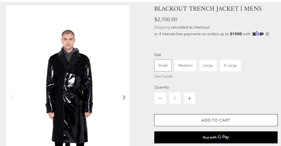 Model stands in a long leather black trench coat looking very very stoic