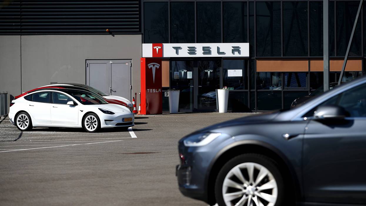 Models S and X sit outside a Tesla Assembly plant.