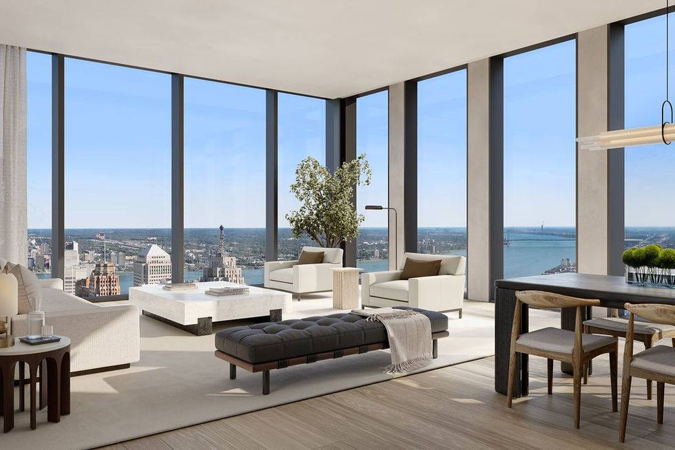 Modern living and dining room with panoramic city and river views from floor-to-ceiling windows.