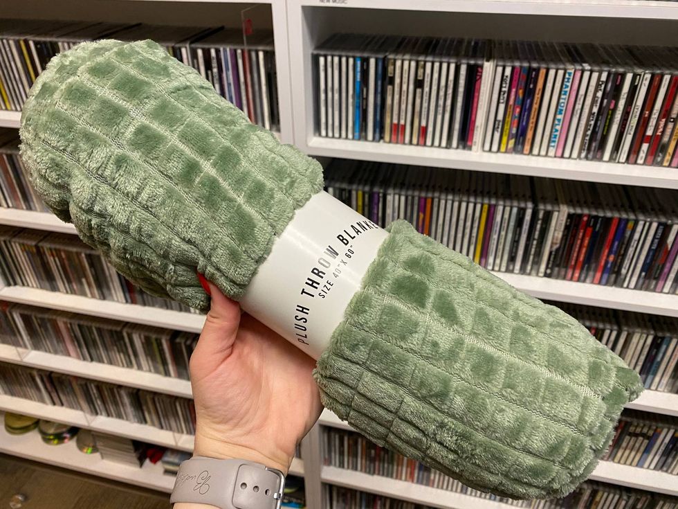 mollie holding a rolled up green blanket