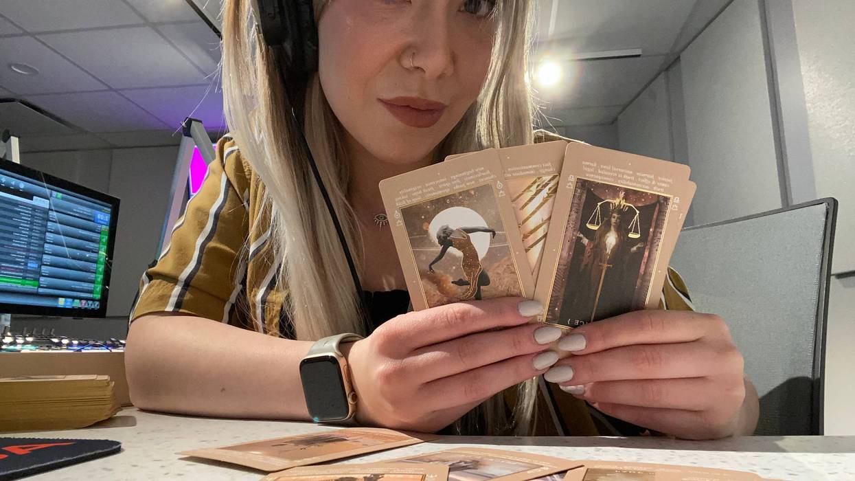 Mollie Kendrick holding cards from the St. Soleil Lucid Dreams tarot deck