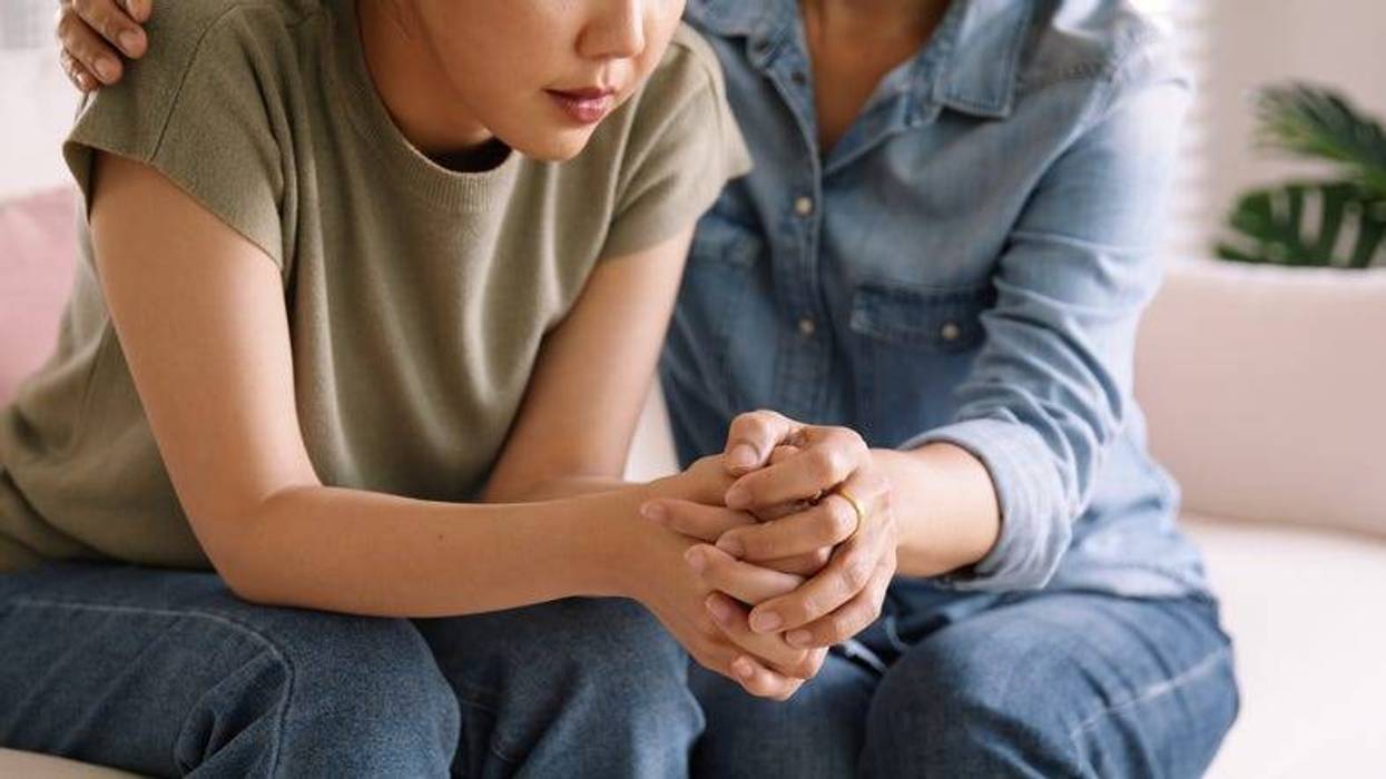 Mom comforting upset teenage daughter
