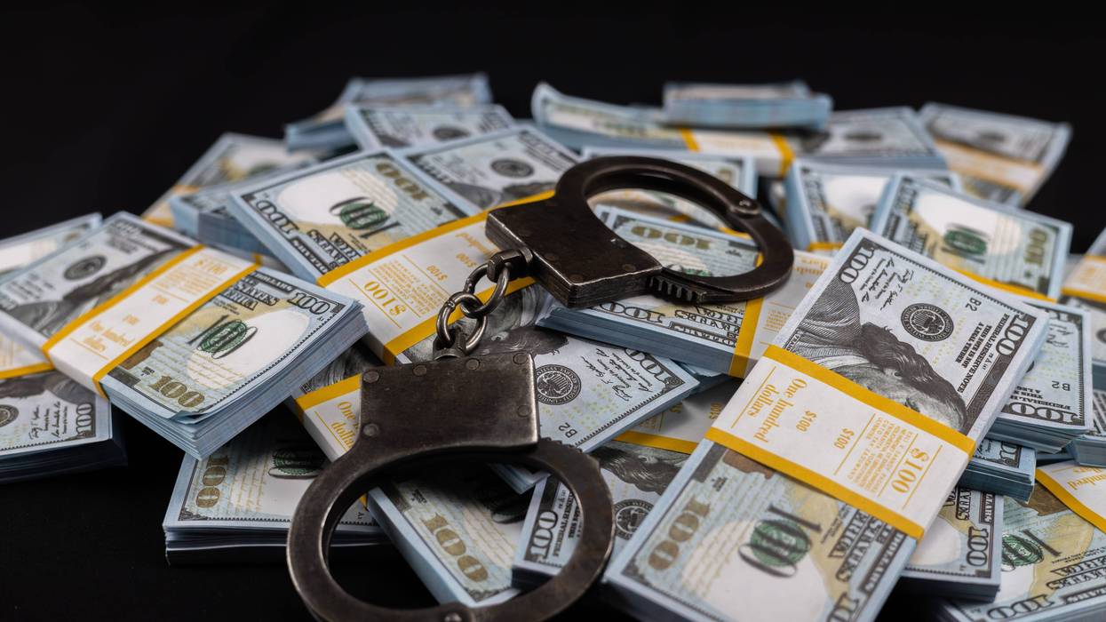 Money and hand cuffs