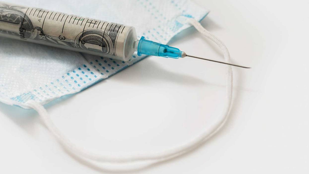 Money in a syringe stock photo.