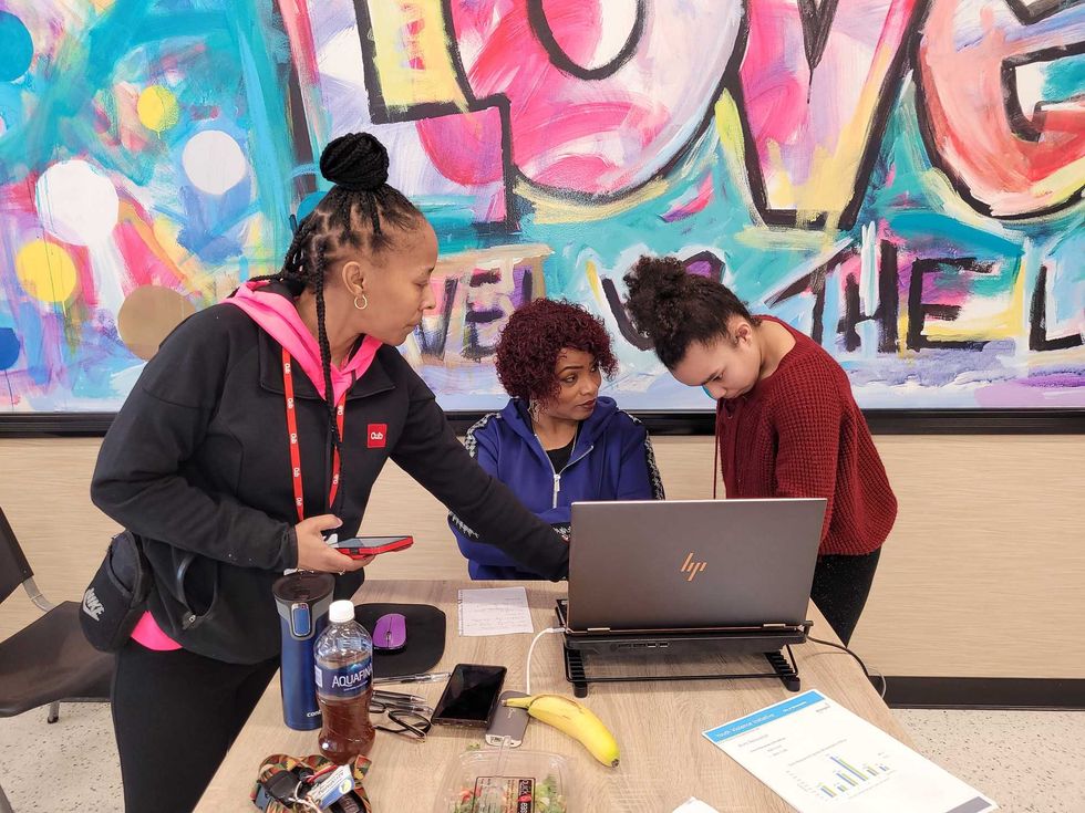 Monique Flowers (left) helps student Jacari Riggins solve a math problem