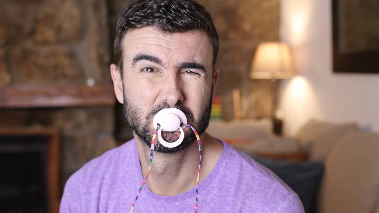 Moody man using a pacifier