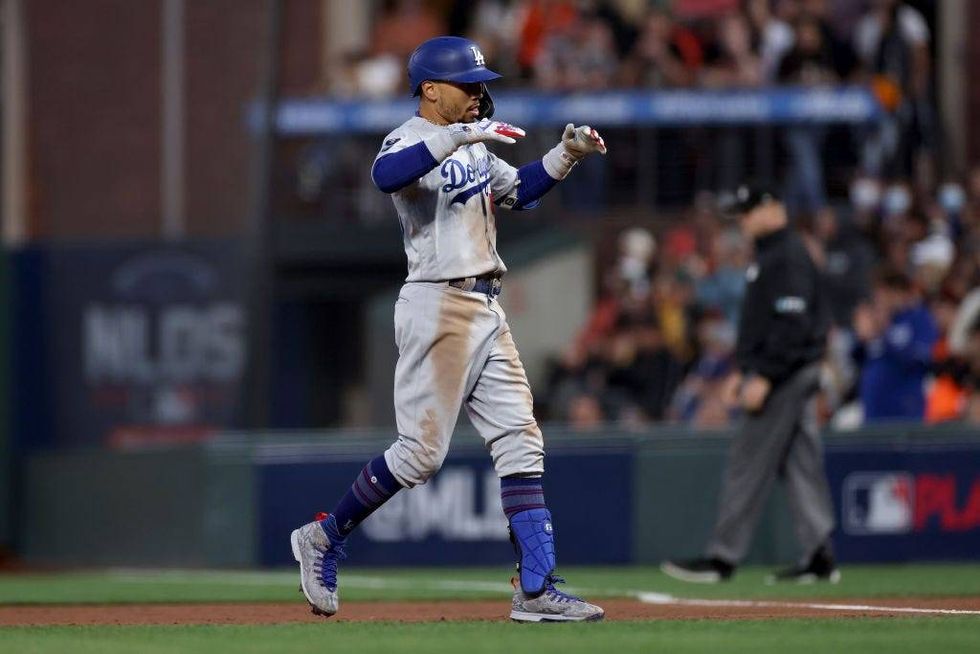 Mookie Betts #50 of the Los Angeles Dodgers celebrates after hitting an RBI single in the second inning against the San Francisco Giants during Game 2.