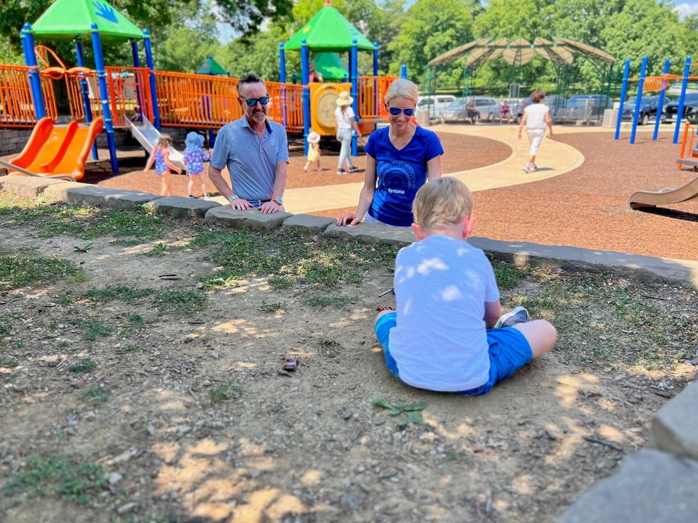 Morgan and April Jensen watch as Morgan, Jr. -- "Jun" -- plays with cars in the dirt at a local playground.
