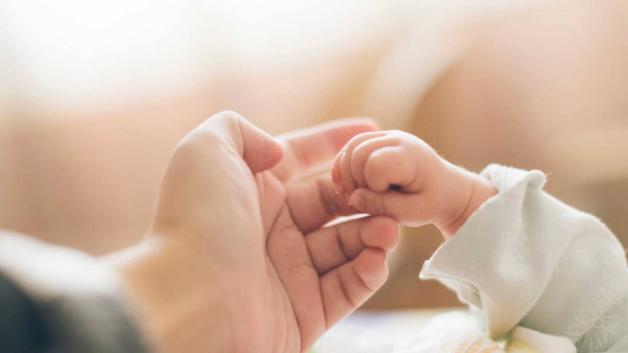 Mother and baby hands stock photo.