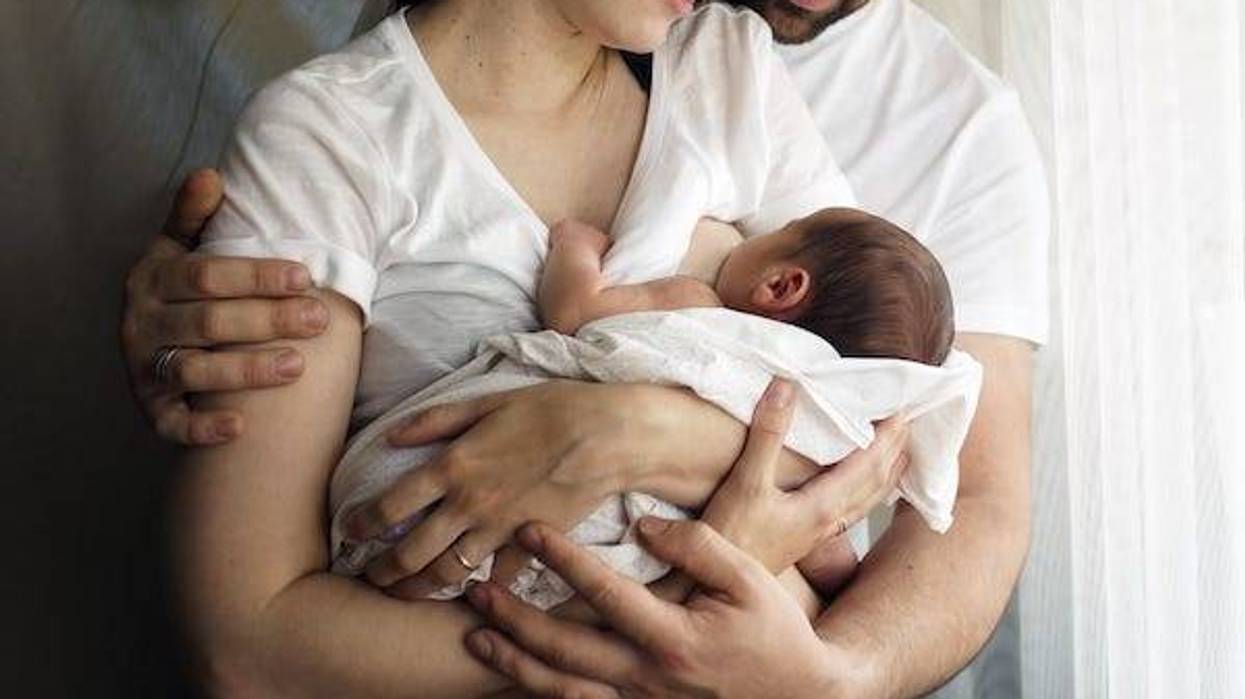 Mother and father look at their newborn baby