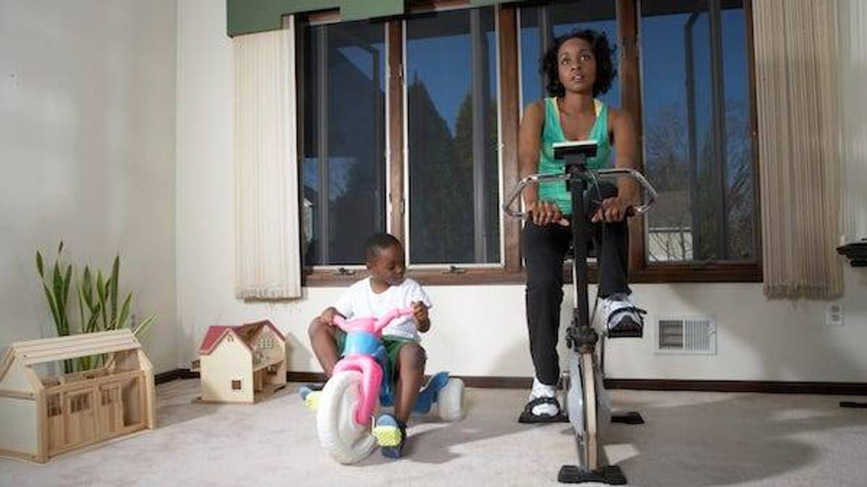 Mother and son doing exercise on exercise bike