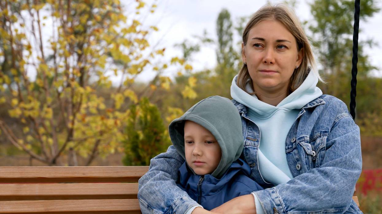 Mother and Son Share Quality Time on a Weekend Swing in the Park