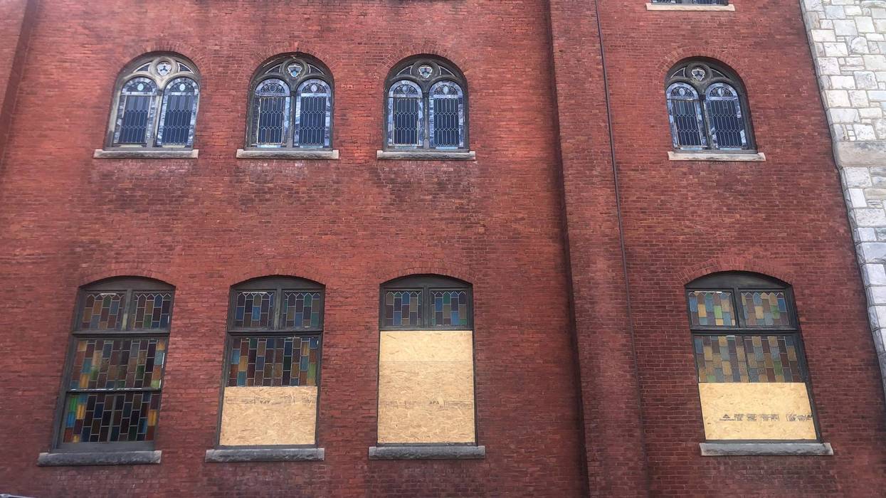 Mother Bethel AME Church exterior, with the damaged stained glass windows boarded up