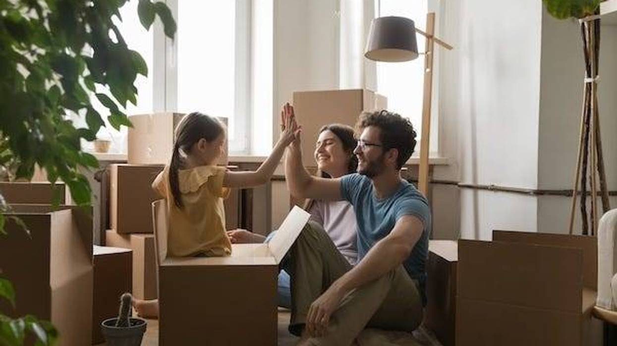 Mother, Father, and daughter moving into an apartment