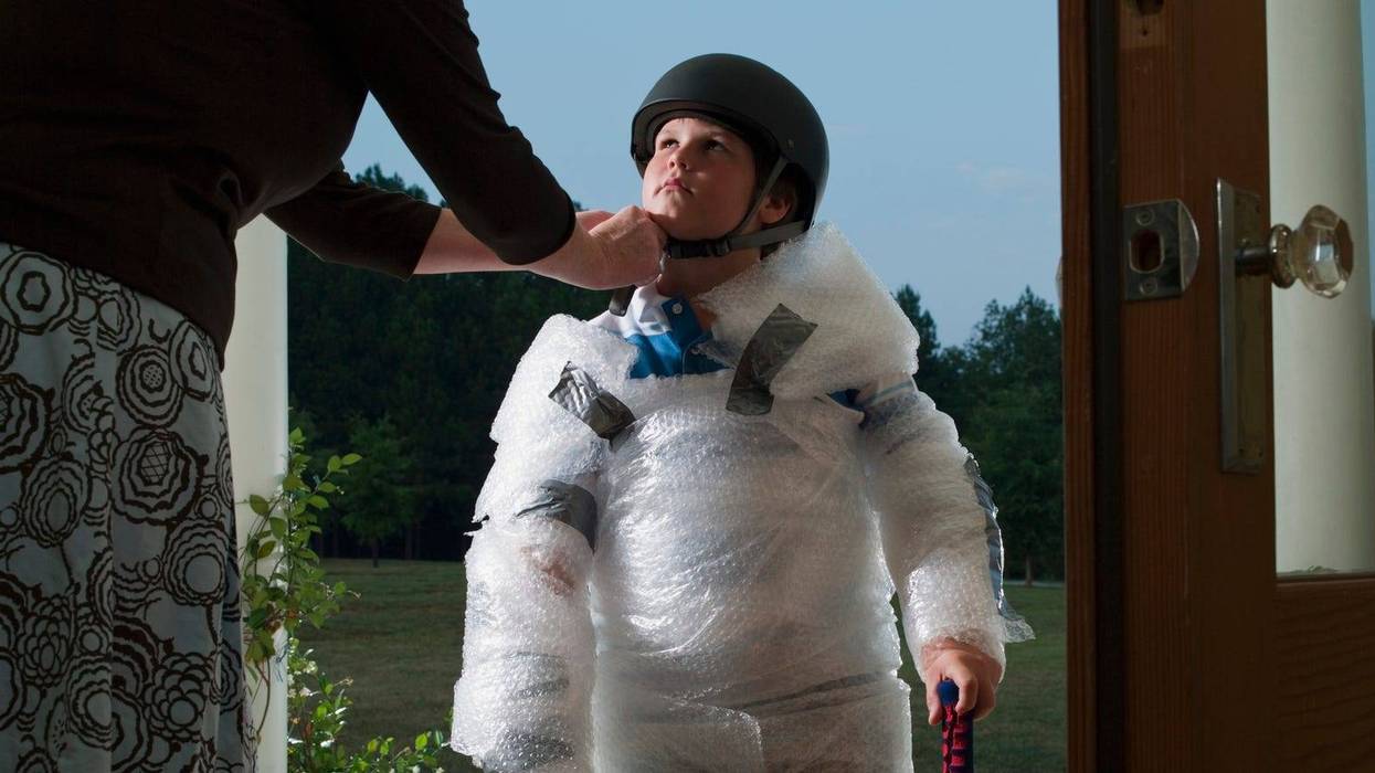 Mother wraps child in bubblewrap to protect him from the world