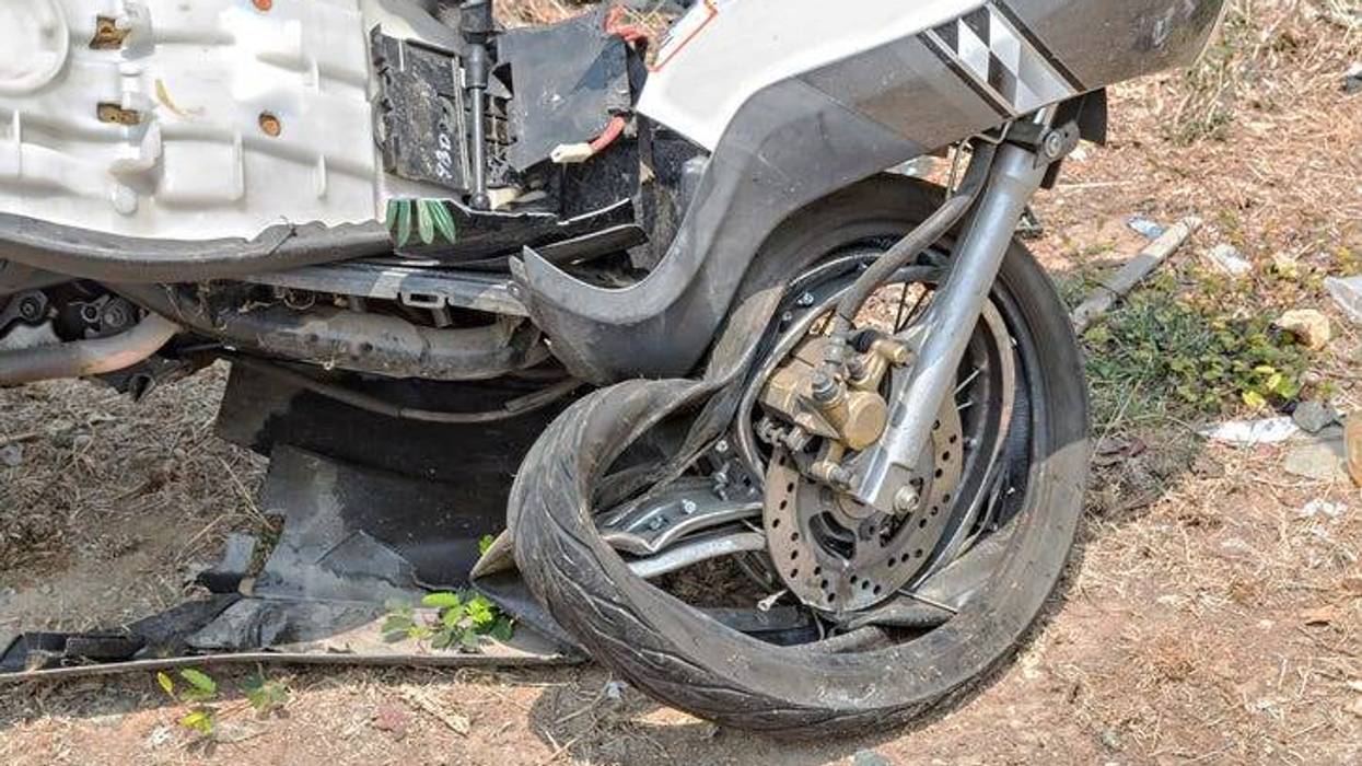 Motorcycle front wheel demolished from accident.