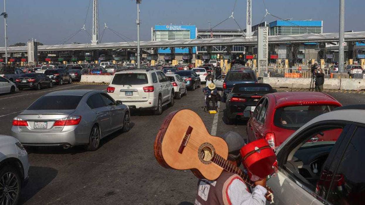 Motorists wait in line to cross the border at the San Ysidro Port of Entry on November 8, 2021 in Tijuana, Mexico. Monday was the official opening of the border to non-essential visitors as COVID restrictions eased. (Photo by Sandy Huffaker/Getty Images)