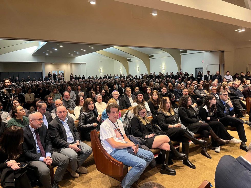 Mourners are seen at the Midway Jewish Center in Syosset