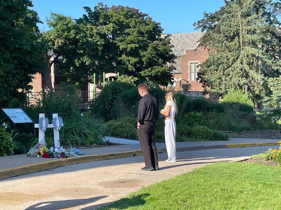 Mourners at a makeshift memorial outside Minneapolis