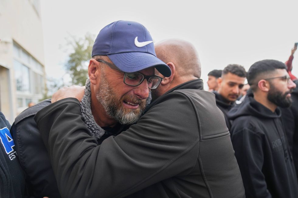 Mourners give condolences to Mohammad Abu Siyam, the father of Palestinian-American Nasrallah Abu Siyam, 19, who, according to the Palestinian Health Ministry, was shot by settlers on Wednesday night, during his funeral in the West Bank village of Mukhmas, east of Ramallah, Thursday, Feb. 19, 2026.